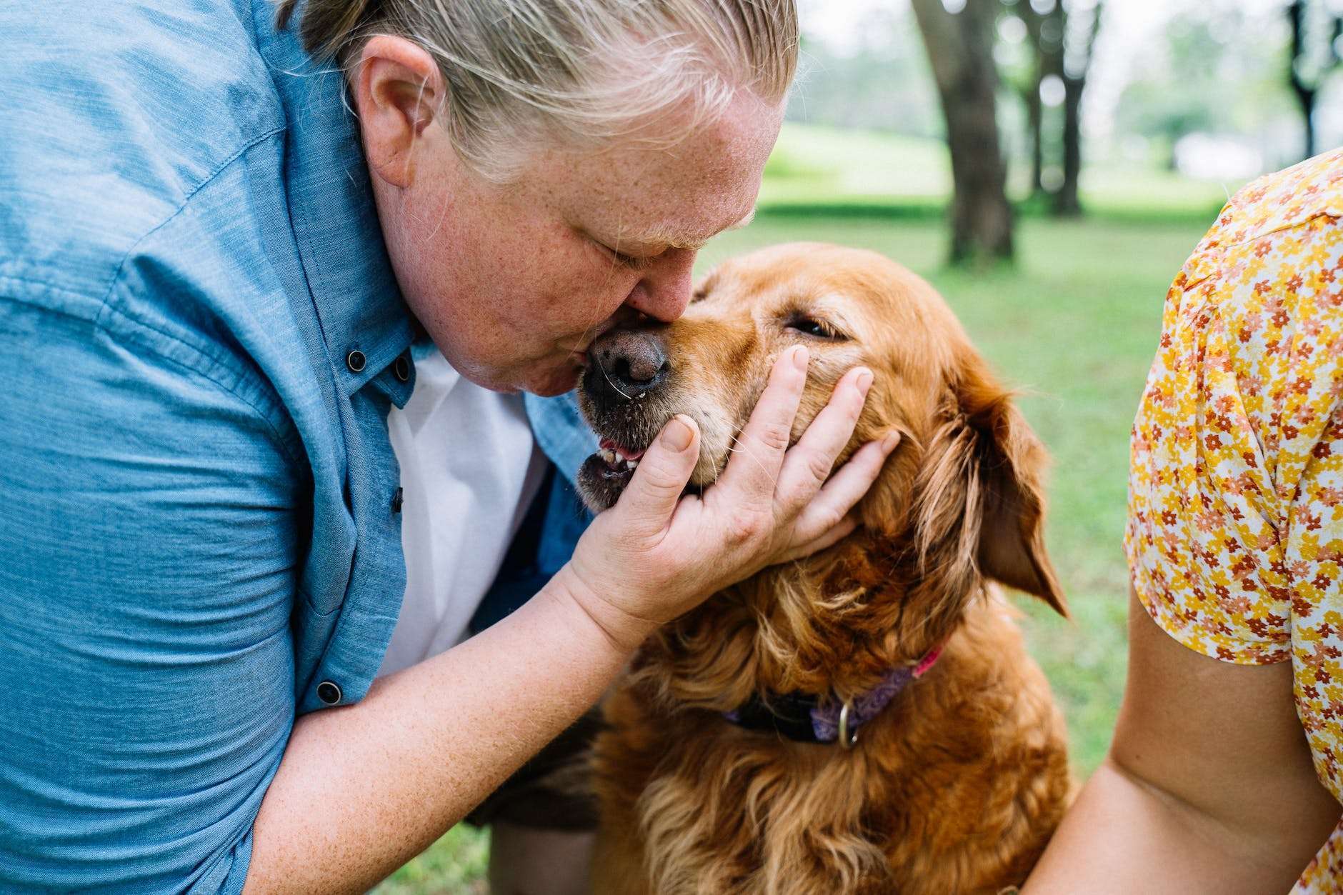 woman kissing her dog